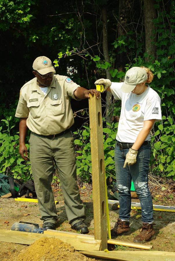 Plumbing a wood fence post with a level