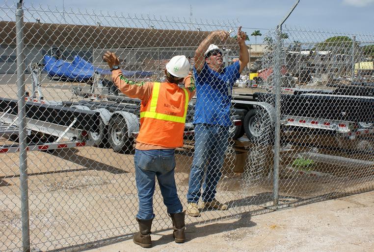Crew installing chain-link fencing