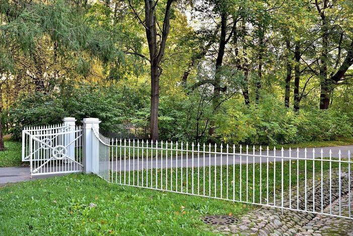 Ornamental metal fence along a lawn